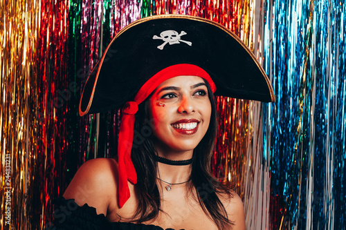 Fototapeta Beautiful young black woman having fun with a fake party pirate costume