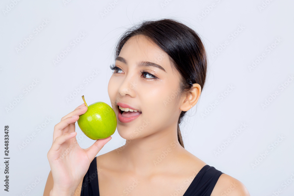Portrait asian woman smile holding and eating green apple fruit and beautiful body diet with fit isolated on white background, girl weight slim with cellulite or calories, health and wellness concept. Portrait asian woman smile holding and eating green apple fruit and beautiful body diet with fit isolated on white background, girl weight slim with cellulite or calories, health and wellness concept.