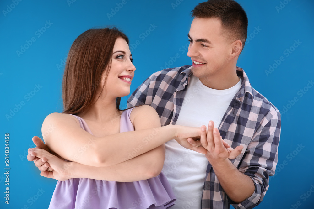 Fotografie Happy young couple holding hands and smiling, romantic relationship and connecti