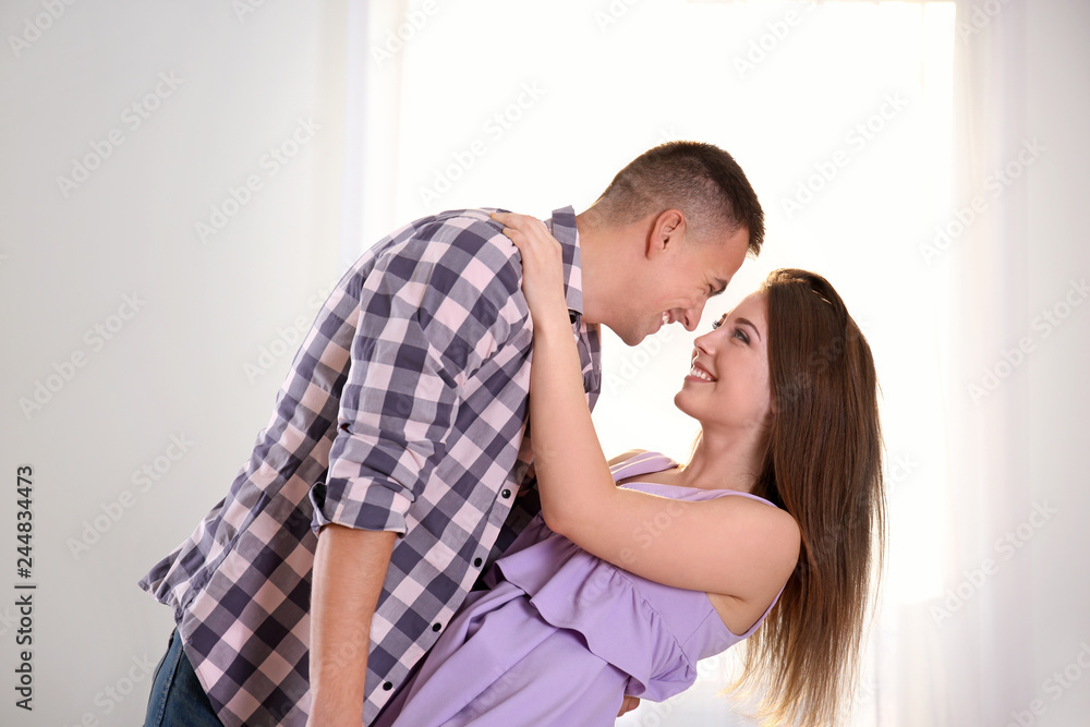 Young couple dancing together indoors Young couple dancing together indoors