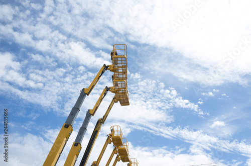 Telescopic Booms over blue sky photo