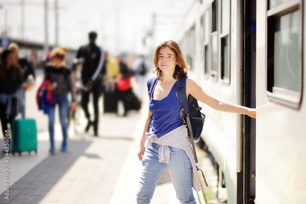 Young woman with backpack getting out of car train.
