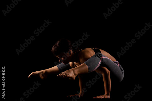 beautiful caucasian girl posing  side lit against black background