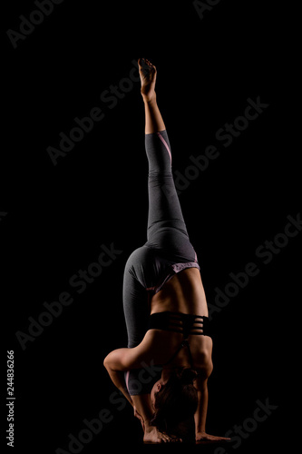 beautiful caucasian girl posing, side lit against black background