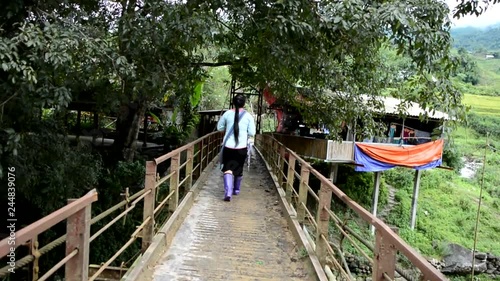 Walking on an old and unstable bridge in Sapa, Vietnam to cross the river with final destination - Cat Cat village vietnamese photo