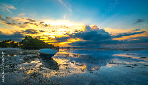 Wooden boat with sunset background