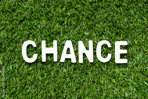 Alphabet letter in word chance on artificial green grass background photo