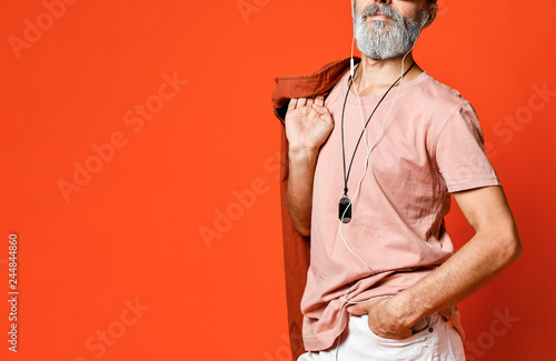 Portrait of cool, manly, fashionable old man holding hand in pocket , looking away camera in sunglasses photo