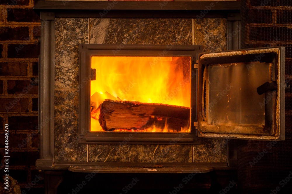 Interior Photo of Wooden Logs - Burning in a Fiery Cabin Stove on a Cold Winter Night