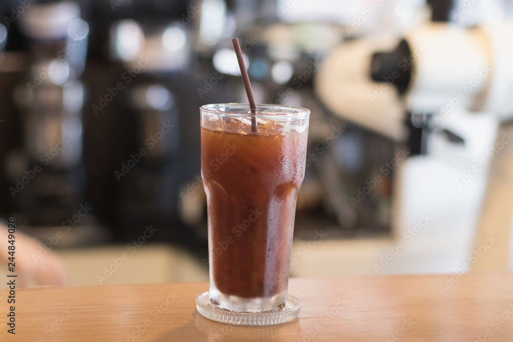 Iced Americano coffee.Background with coffee machine and barista. Iced Americano coffee.Background with coffee machine and barista.