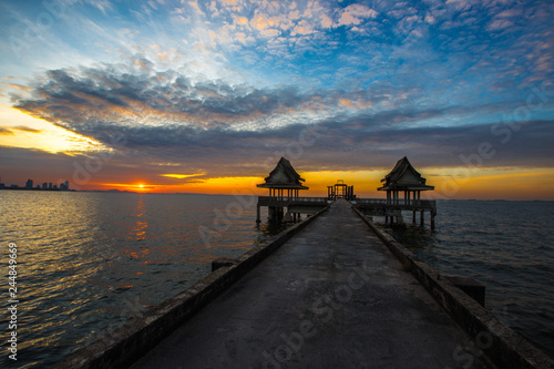 The background of the bridge that stretches into the sea  with buildings  churches  accommodation for sun shading or sheltering from the rain  with a secret light on the lake is a natural beauty.