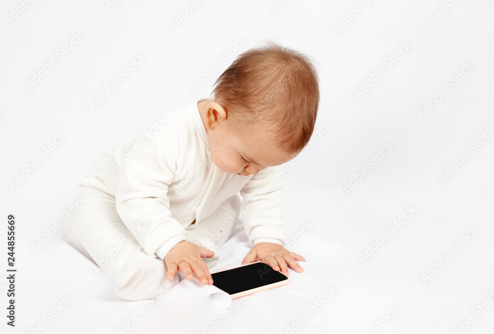 Baby holding a mobile phone isolated on white background Baby holding a mobile phone isolated on white background