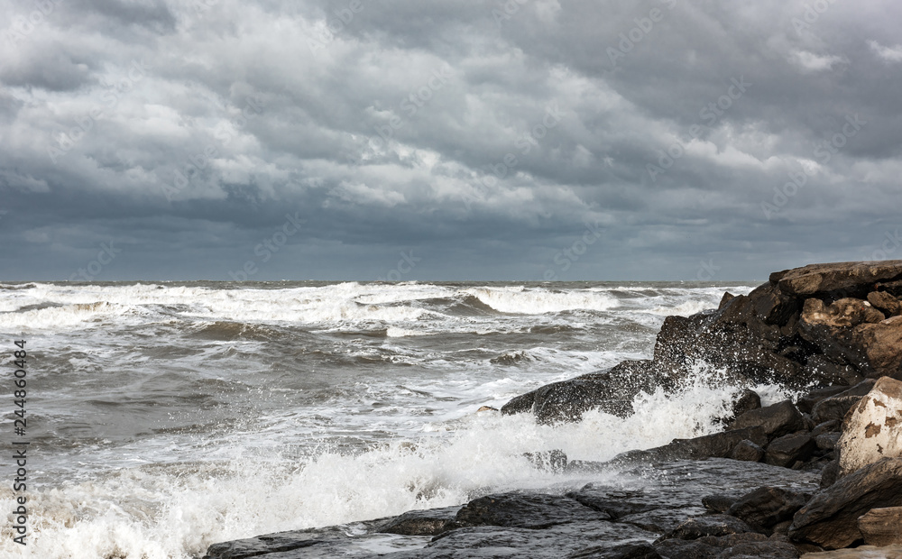 Stormy sea, the waves break on the rocks