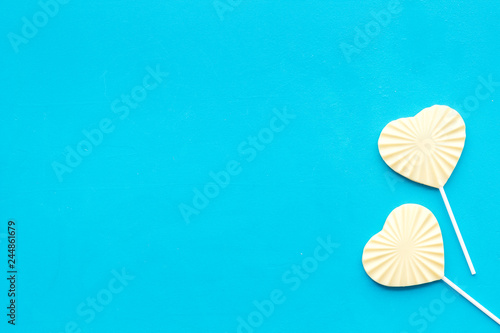 Heart-shaped lollipop for Valentine s day on blue background top view copy space