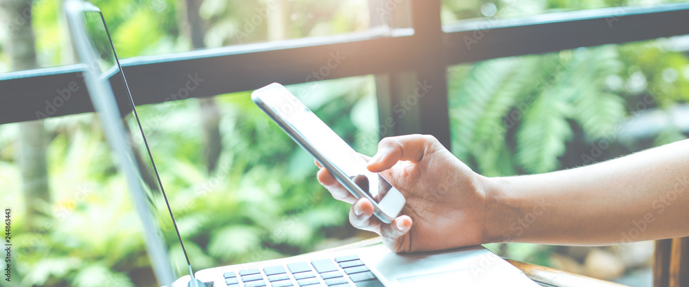 Business woman hand is using a mobile phone.