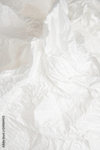 A crumpled piece of recyclable and biodegradable white tissue packaging paper. photo