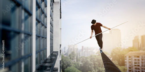 Brave ropewalker on cable. Mixed media photo