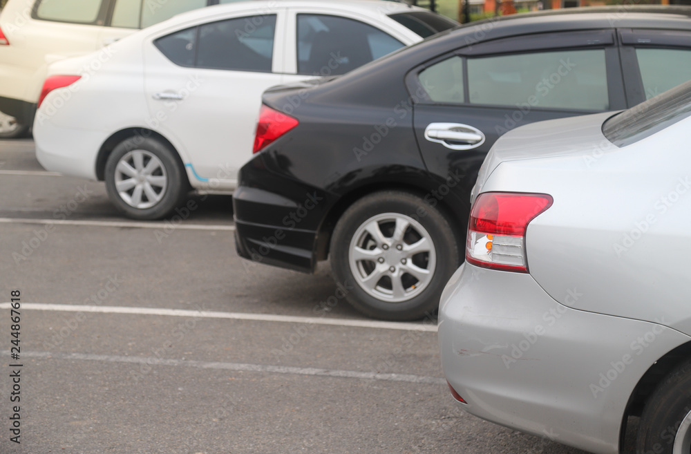 Closeup of back or rear side of bronze car parking in parking area in the evening of sunny day. Closeup of back or rear side of bronze car parking in parking area in the evening of sunny day.
