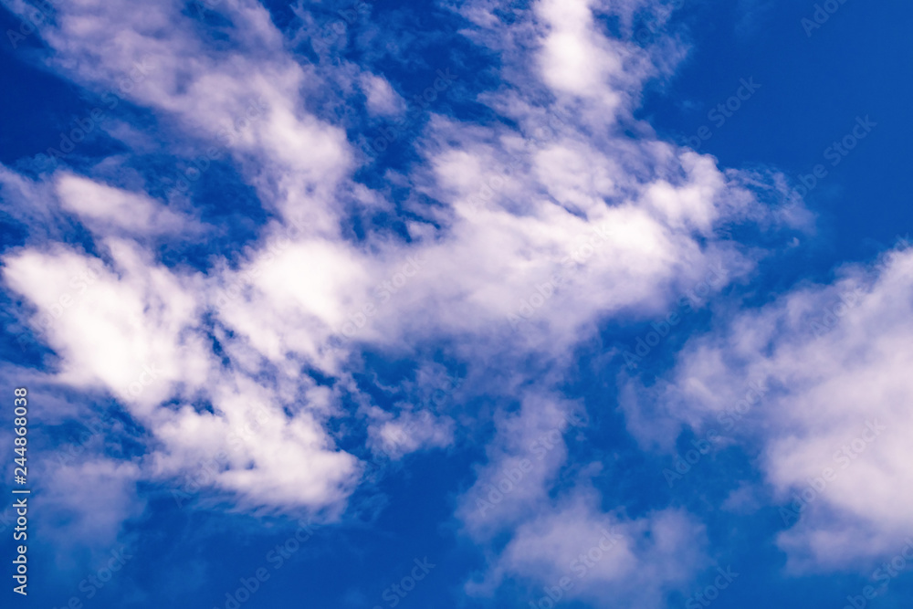 Fototapeta premium Blue sky with white and purple clouds.