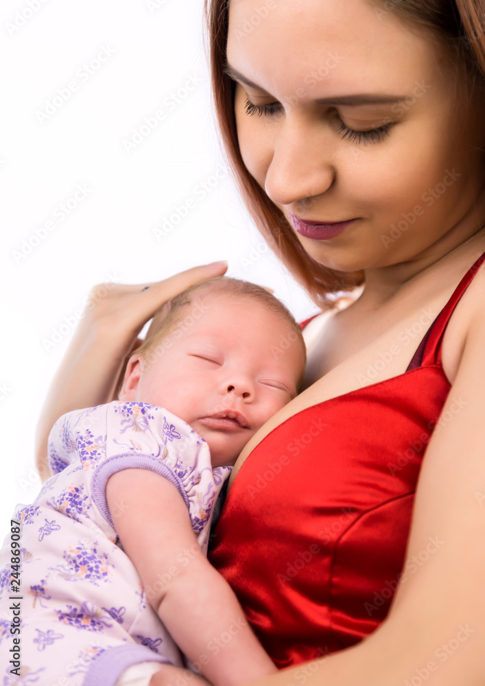 Pretty woman holding a newborn baby in her arms on a white background Pretty woman holding a newborn baby in her arms on a white background