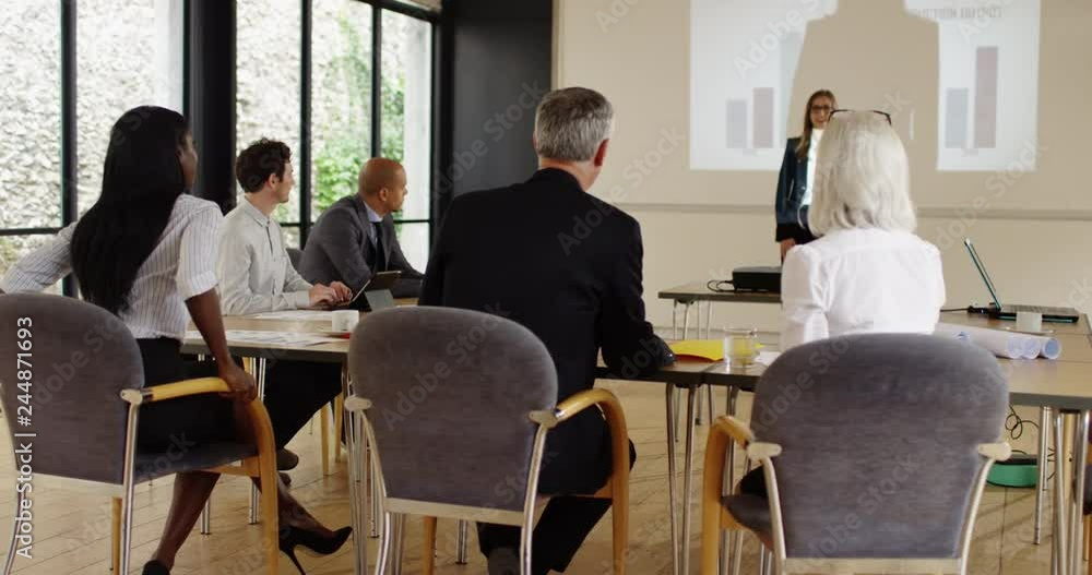 4k,Businesswoman gives presentation to her business colleagues in a conference room with graphs and pie charts 4k,Businesswoman gives presentation to her business colleagues in a conference room with graphs and pie charts