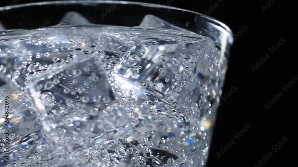 Mineral (soda) water with gas in a glass with ice Mineral (soda) water with gas in a glass with ice