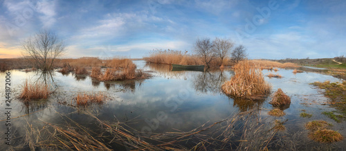 Panorama of the river bank during the spring flood. There is a b