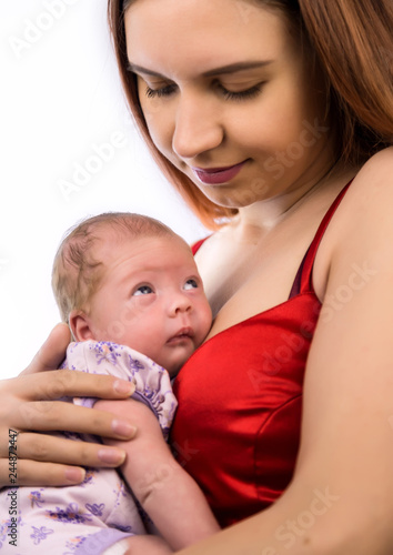 pretty woman kisses and hugging a newborn