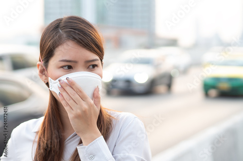 City air pollution concept. Close up woman wearing N95 mask to protect pm2.5 air pollution in city