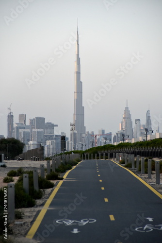 Bild auf Leinwand Dubai skyline from Nad Al Sheba bicycle track road, Dubai, United Arab Emirates
