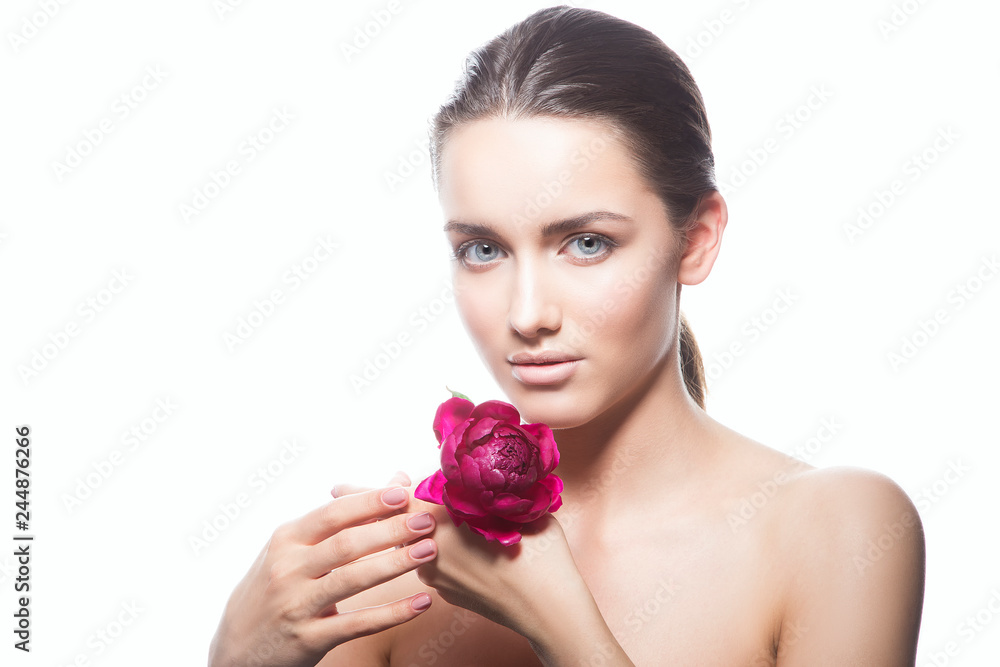 Attractive beauty model girl portrait, pnk fresh flower in hands, blue eyes, clean skin, natural nude make-up, isolated on white background. Copy space Attractive beauty model girl portrait, pnk fresh flower in hands, blue eyes, clean skin, natural nude make-up, isolated on white background. Copy space