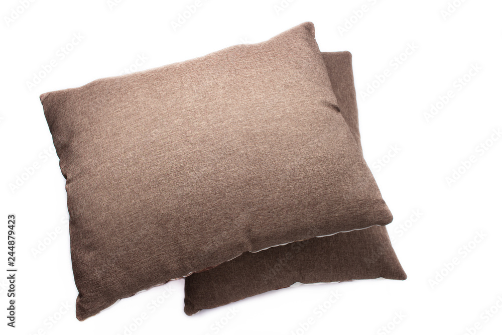 Two brown pillows on white background, top views