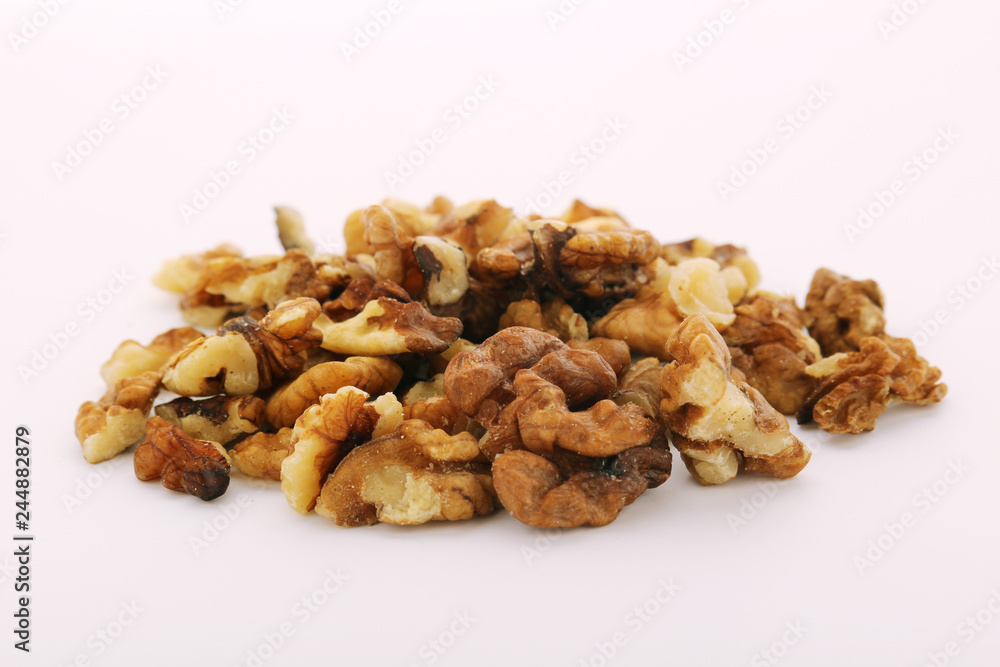 A pile of peeled walnuts at white background