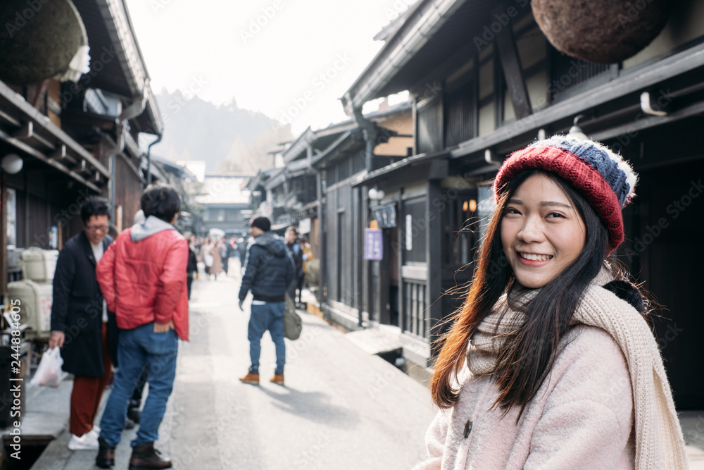 Happy Asian Girl with pink overcoat in Takayama old town, Gifu, Japan during cold weather in winter. Happy Asian Girl with pink overcoat in Takayama old town, Gifu, Japan during cold weather in winter.