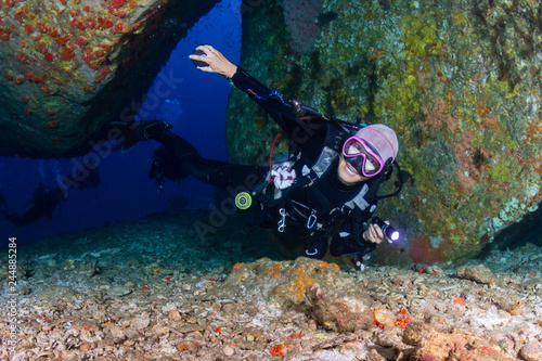 SCUBA divers exploring a tropical coral reef