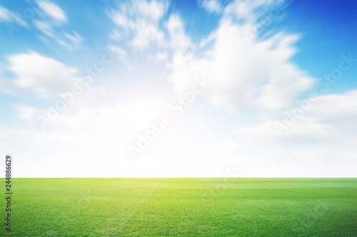 Football green field with cloud blue sky background. Landscape outdoor sport 