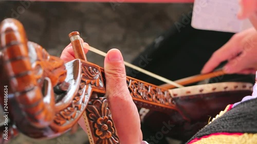 Guslar playing a gusle. Man playing gusle. Traditional music instrument gusle in Montenegro