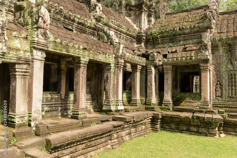 Temple colonnade covered with lichen by lawn