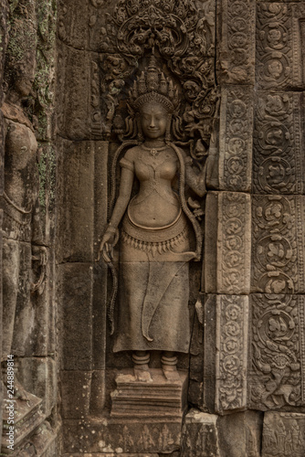 Statue of woman on ruined temple wall