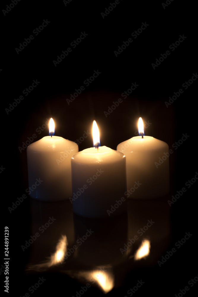 candles with reflection burning on black background with copy space candles with reflection burning on black background with copy space