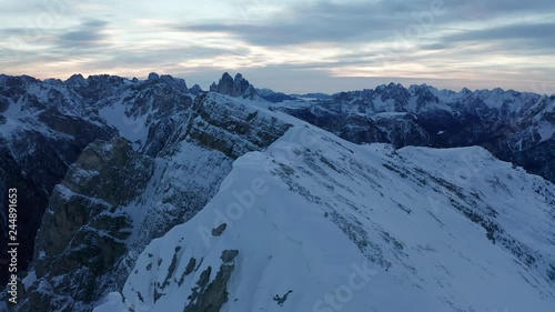 Aerial parallax around a ridge line near Durrenstein, a large mountain high up in the beautiful Dolomites of South Tyrol, Italy, looking out towards the stunning Tre Cime di Lavaredo
