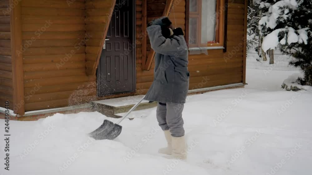 Caucasian Man Hardly Cleans A Shovel Yard Of Snow In The Winter After Snowstorm Caucasian Man Hardly Cleans A Shovel Yard Of Snow In The Winter After Snowstorm