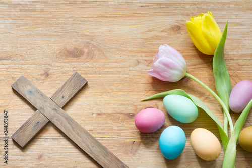 Photography Easter eggs and cross on abstract wooden spring background