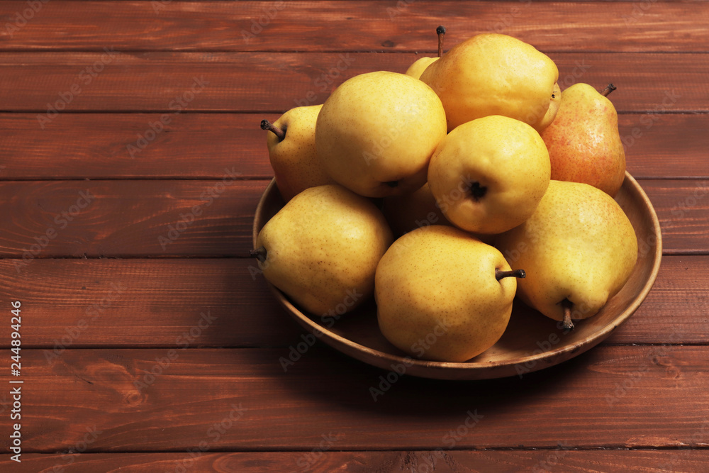 Ripe pears on wooden table. Space for text. Top view.
