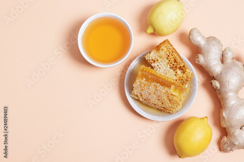 Honey, lemon and ginger on a pink background