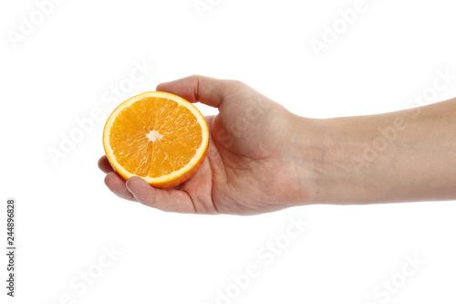 A slice of ripe orange in hand isolated on white background.