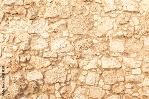 Background of ancient brick wall. Texture of old amphitheater stone. Texture of an ancient brick wall made of sandstone. Archaeological excavations