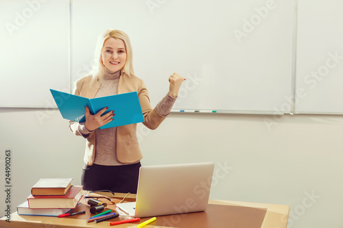 Teacher giving lesson to students in classroom photo