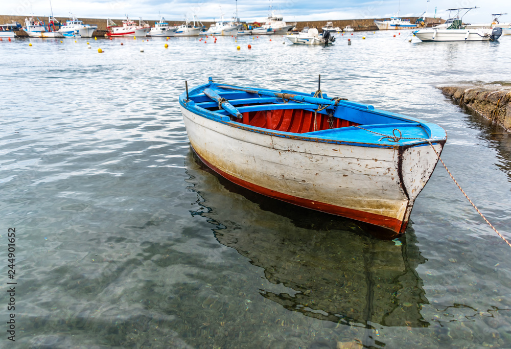 Small Old Fishing Boat in a Harbor on the Southern Mediterranean Coast of Italy Small Old Fishing Boat in a Harbor on the Southern Mediterranean Coast of Italy