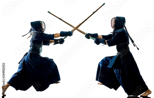 Fotografering two Kendo martial arts fighters combat fighting in silhouette isolated on white